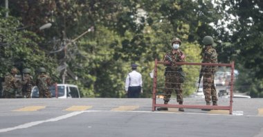Armed military men stand guard behind barricades as they block a road after several explosions occurred in the downtown area in Yangon, Myanmar, Aug. 10, 2021. (EPA Photo)