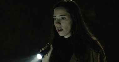 Rebecca Hall holds a flashlight, in a scene from the film "The Night House." (Searchlight Pictures via AP)