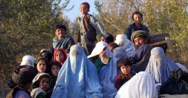Residents of the northeastern Afghan village of Kalaqata in Takhar province fleeing the frontline area as U.S. fighter planes bomb Taliban positions nearby, Nov. 4, 2001. (AFP Photo)