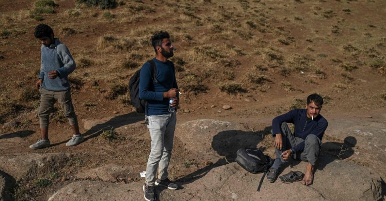Afghan migrants rest while waiting for transport by smugglers after crossing the Iran-Turkish border on Aug. 15, 2021, in Tatvan, on the western shores of Lake Van, eastern Turkey. (Photo by Ozan KOSE / AFP)