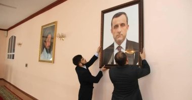 Afghan embassy staff hang a portrait of Afghan Vice President Amrullah Saleh, who declared himself the "legitimate caretaker president," on the wall at the embassy in Dushanbe, Tajikistan, in this picture released August 18, 2021. (Embassy of the Islamic Republic of Afghanistan in Dushanbe via Reuters)