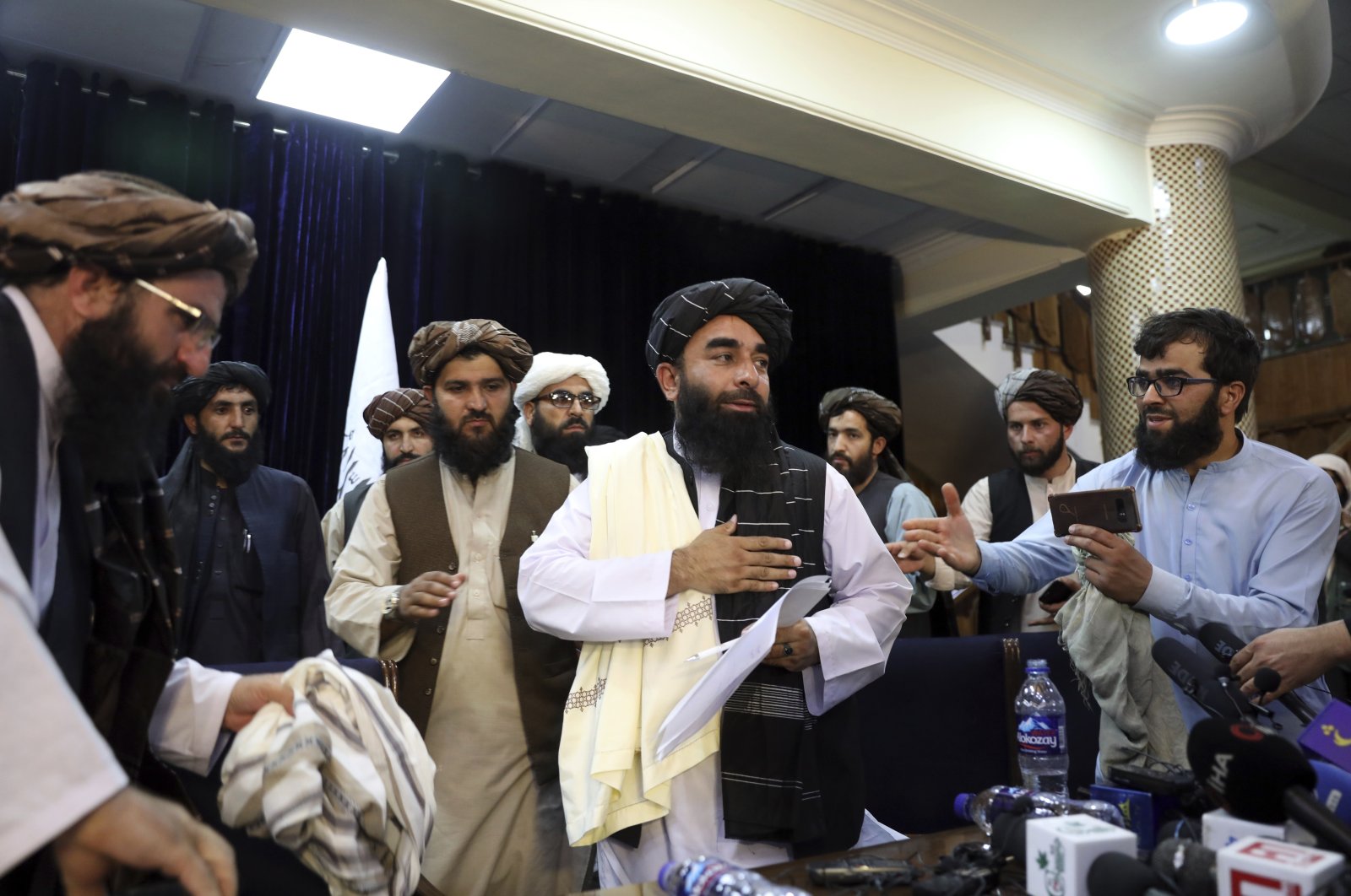 Taliban spokesperson Zabihullah Mujahid (C) leaves after his first news conference, in Kabul, Afghanistan, Aug. 17, 2021. (AP Photo)