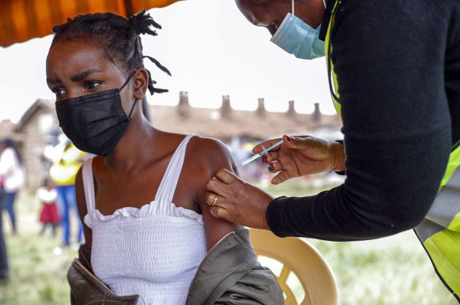 A Kenyan woman receives a dose of the AstraZeneca coronavirus vaccine donated by Britain, at the Makongeni Estate in Nairobi, Kenya, Aug. 14, 2021. (AP Photo)
