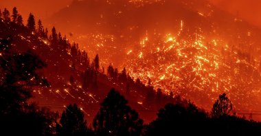 Seen in a long exposure photograph, embers light up hillsides as the Dixie Fire burns near Milford in Lassen County, California, U.S., Aug. 17, 2021. (AP Photo)