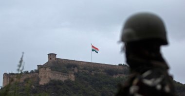 An Indian paramilitary soldier stands guard as the Indian national flag flutters on Hari Parbat Fort during the celebrations to mark India's 75th Independence Day in Srinagar, India, Aug. 15, 2021. (AFP Photo)