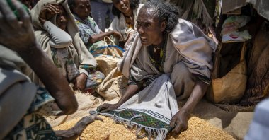 An Ethiopian woman argues with others over the allocation of yellow split peas after it was distributed by the Relief Society of Tigray in the town of Agula, in the Tigray region of northern Ethiopia, May 8, 2021. (AP Photo)