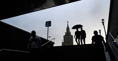 People enter the underground passage during a rain shower in Moscow, on Aug. 18, 2021. (AFP Photo)
