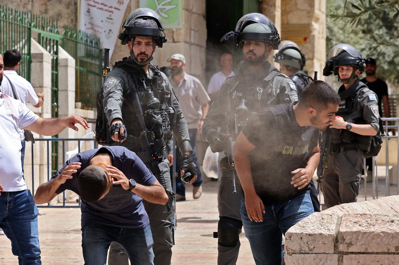 Israeli security forces spray Palestinian protesters in Jerusalem's Old City on May 10, 2021, as a planned march marking Israel's 1967 takeover of the holy city threatened to further inflame tensions. (AFP Photo)
