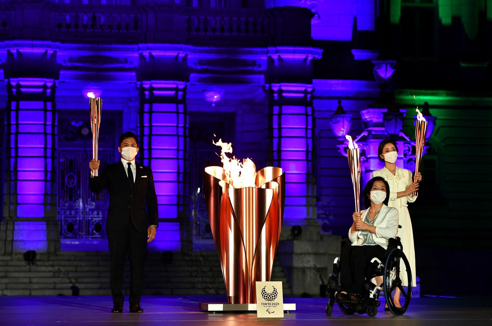 Tokyo 2020 Torch Relay Official Ambassadors Tadahiro Nomura (L), Aki Taguchi (2nd R), Satomi Ishihara (R) take part in the Paralympic Flame Lighting Ceremony at the State Guest House Akasaka Palace, Tokyo, Japan, Aug. 20, 2021. (AFP Photo)
