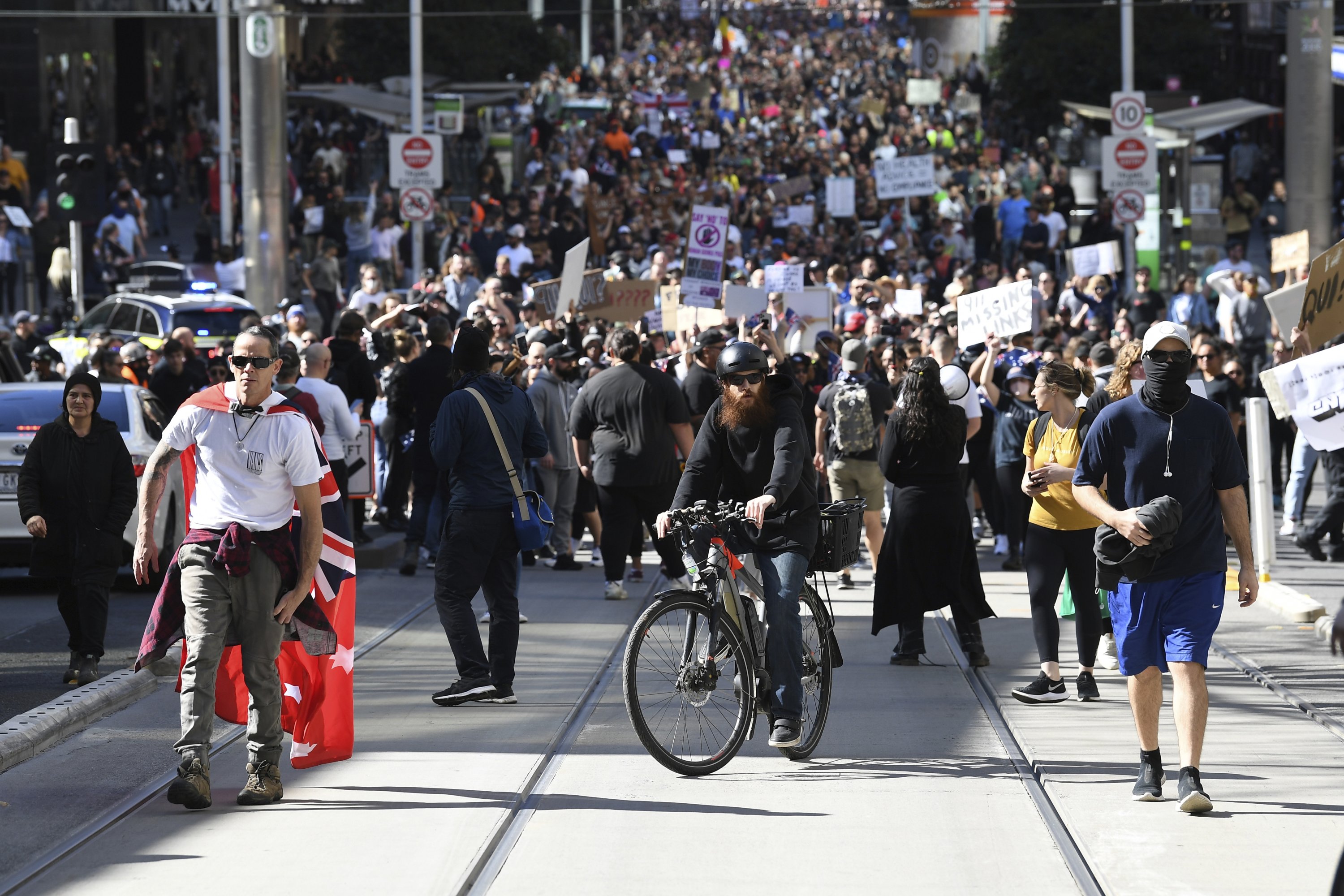 Hundreds of protesters march on a street during an anti-lockdown protest in Melbourne, Australia, Saturday, Aug. 21, 2021. (James Ross/AAP Image via AP)