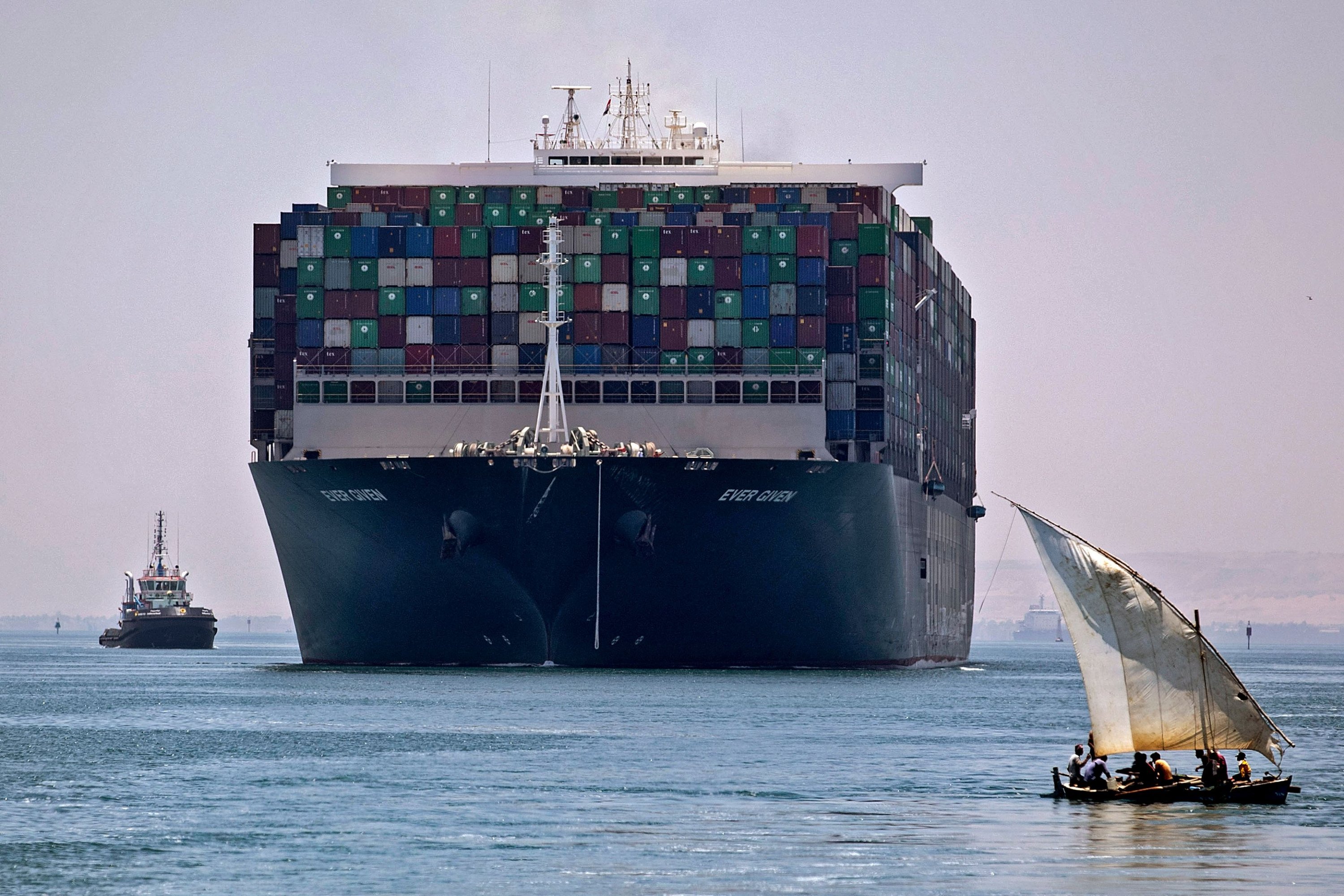 This file picture taken July 7, 2021 shows the Ever Given container ship sailing near a felucca along Egypt