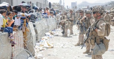 In this image courtesy of the U.S. Marine Corps, soldiers provide assistance during an evacuation at Hamid Karzai International Airport, Kabul, Afghanistan, on August 20, 2021. (Photo by Nicholas Guevara / US Marine Corps via AFP) 