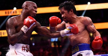 Philippines' Manny Pacquiao (R) fights against Cuba's Yordenis Ugas in the WBA Welterweight Championship boxing match at T-Mobile Arena in Las Vegas, U.S., Aug. 21, 2021. (AFP Photo)