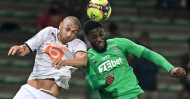 Lille's Turkish forward Burak Yılmaz (L) fights for the ball in the air with Saint-Etienne's French forward Jean-Philippe Krasso during a French L1 match, Saint-Etienne, France, Aug. 21, 2021.(AFP Photo)