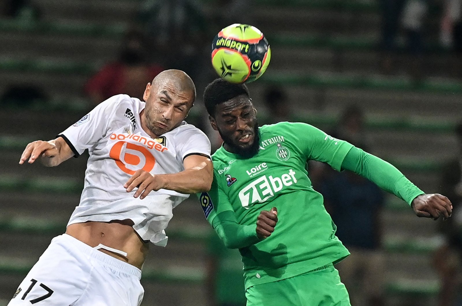 Lille's Turkish forward Burak Yılmaz (L) fights for the ball in the air with Saint-Etienne's French forward Jean-Philippe Krasso during a French L1 match, Saint-Etienne, France, Aug. 21, 2021.(AFP Photo)