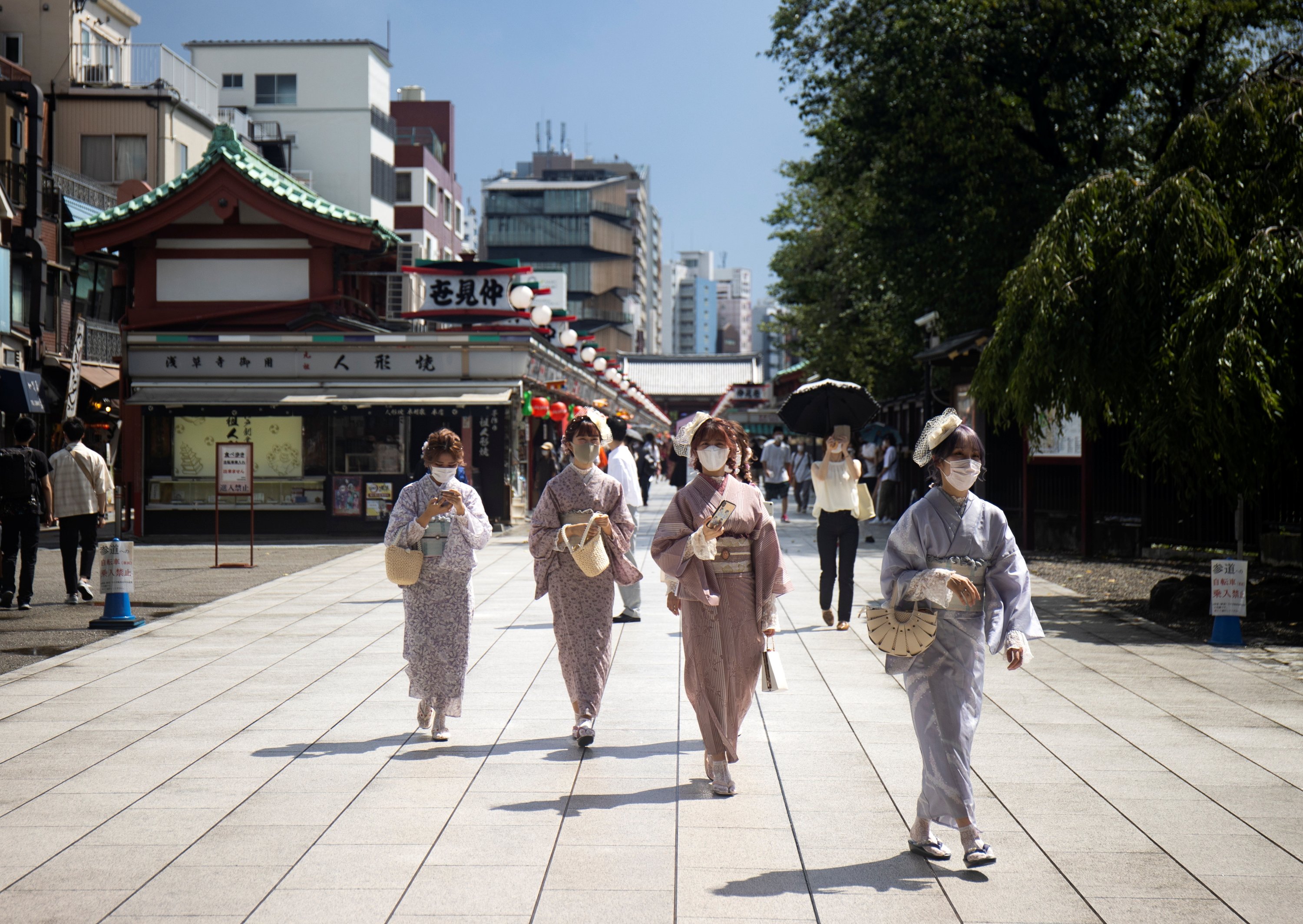 Women wearing kimonos walk at the Senso-ji temple area in Tokyo, Japan, Aug. 18, 2021. (Reuters Photo) 