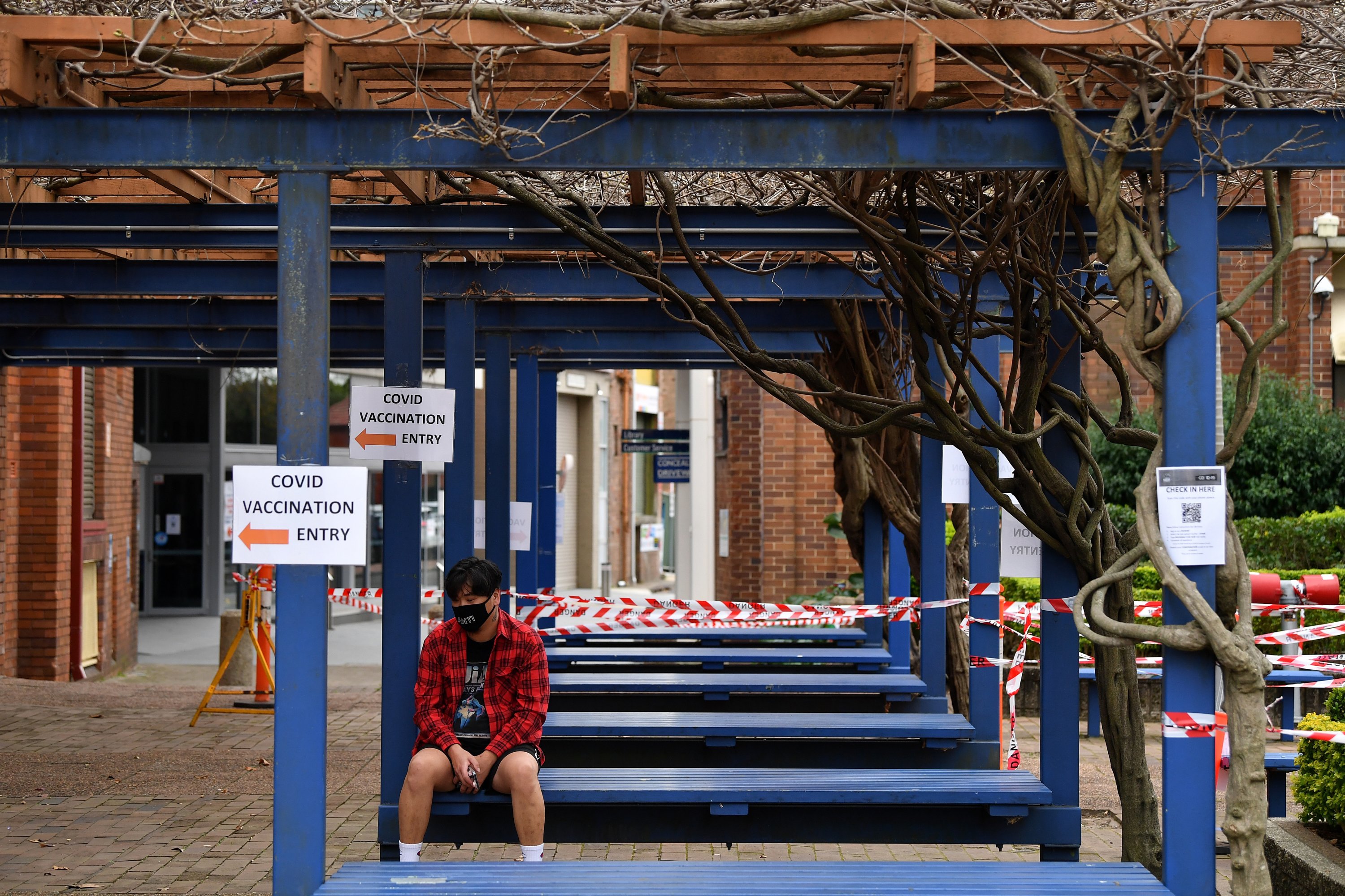 A man waits outside near the AstraZeneca (Vaxzevria) COVID-19 Vaccination Clinic at Rockdale in Sydney, New South Wales, Australia, Aug. 23, 2021. (EPA Photo)