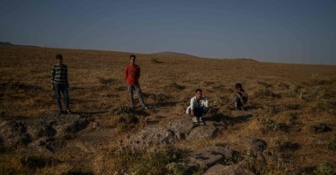 Afghan migrants rest while waiting for transport from smugglers after crossing the Iran-Turkish border, Tatvan, on the western shores of Lake Van, eastern Turkey, on Aug. 15, 2021. (Ozan KÖSE / AFP)