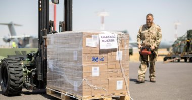 A soldier loads aid supplies destined for Afghanistan on a transport aircraft of the German Air Force at Tashkent airport, Uzbekistan, Aug. 22, 2021. (Handout from German Air Force via EPA)