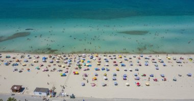 People are seen on a beach in Çeşme, a resort town in the Aegean province of Izmir, Turkey, Aug. 20, 2021. (AA Photo)