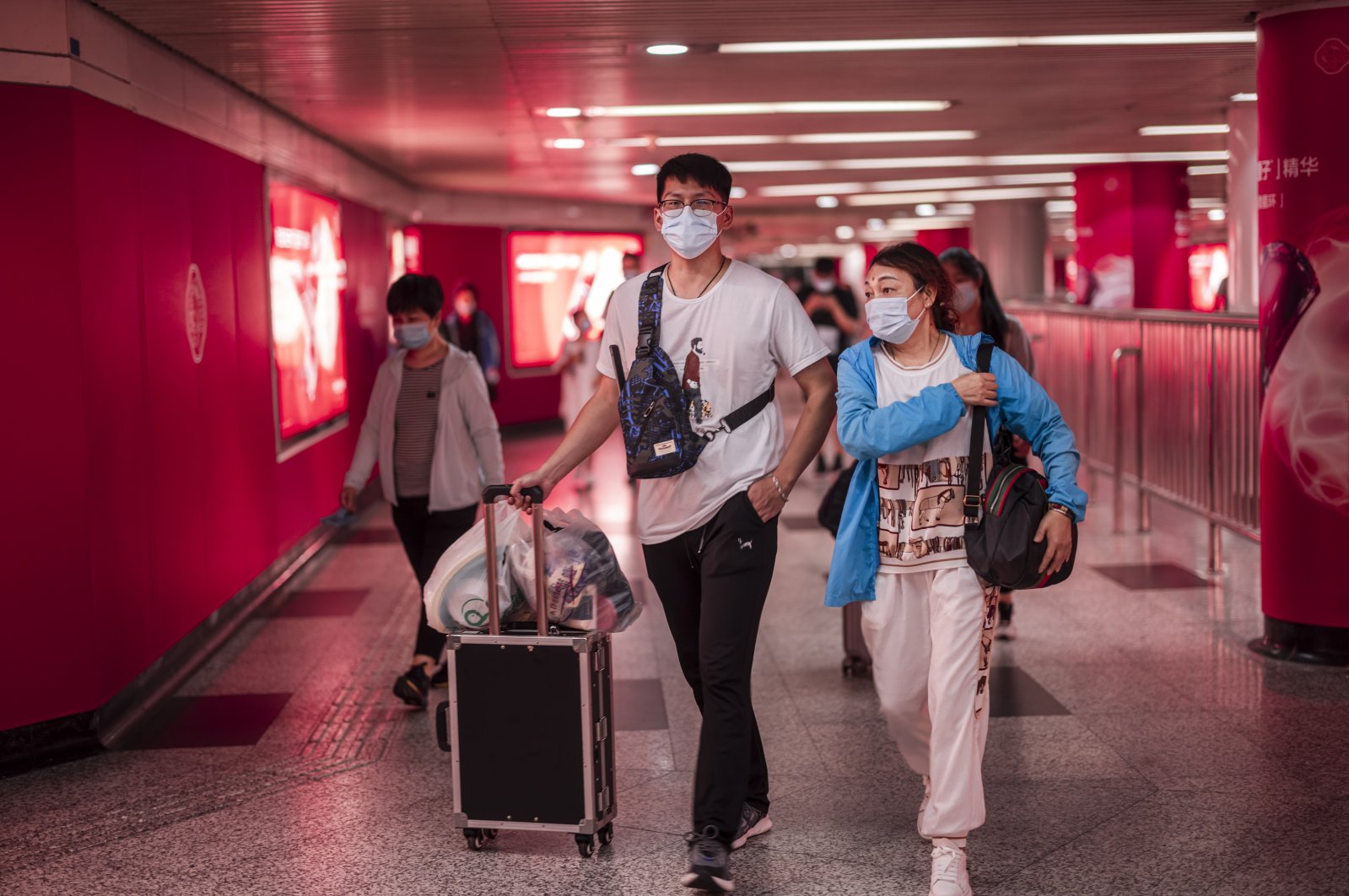 People enter form the subway station to the Pudong International Airport in Shanghai, China, Aug. 22, 2021. (EPA Photo)