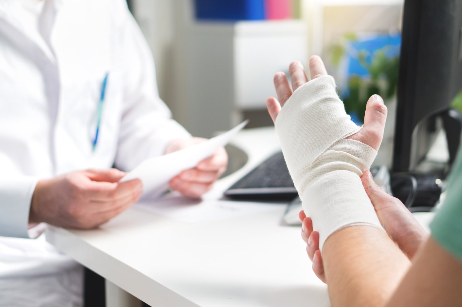 An Injured patient shows her broken wrist to the doctor in the emergency room. (Shutterstock Photo)