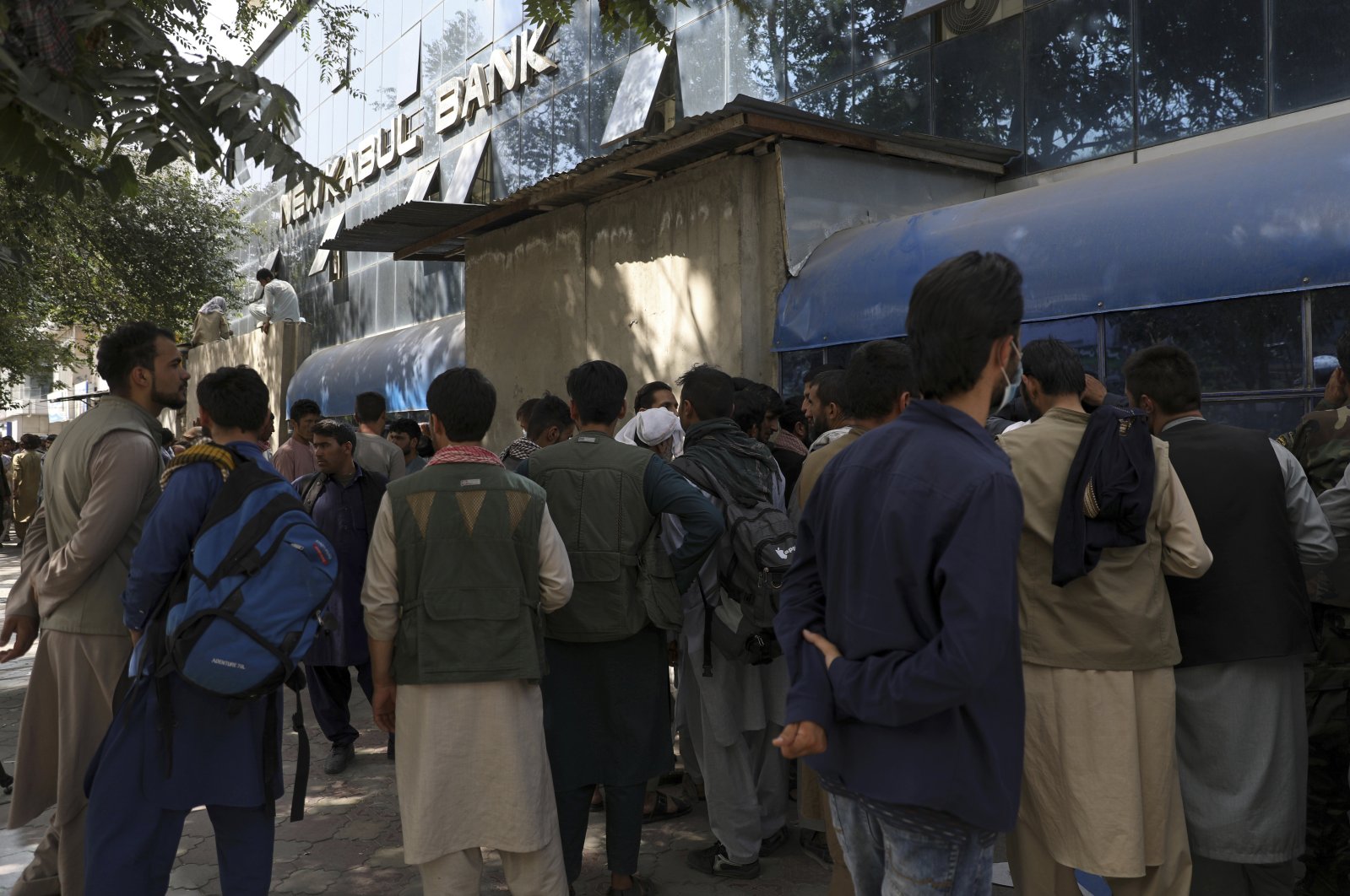Afghans wait in long lines for hours to try to withdraw money, in front of Kabul Bank, in Kabul, Afghanistan, Aug. 15, 2021. (AP Photo)