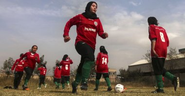 Members of the Afghan women's national football team warm-up before a friendly match against the ISAF (International Security Assistance Force) female football team at the ISAF headquarters in Kabul, Afghanistan, Oct. 29, 2010. (AP Photos)