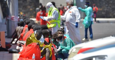 Red Cross members take care of migrants rescued at the La Restringa port in El Hierro, Canary Islands, Spain, Aug. 23, 2021. (EPA Photo)