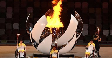 Three torchbearers pose after lighting the Paralympic cauldron during the opening ceremony for the Tokyo 2020 Paralympic Games at the Olympic Stadium in Tokyo, Japan, Aug. 24, 2021. (AFP Photo)