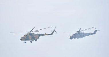 The Hungarian Air Force’s Mi-17 transport helicopter (left) and a Mi-24 fighter helicopter fly low during the St. Stephen's Day celebration in Budapest, Hungary, Aug. 20, 2021. (Reuters Photo)