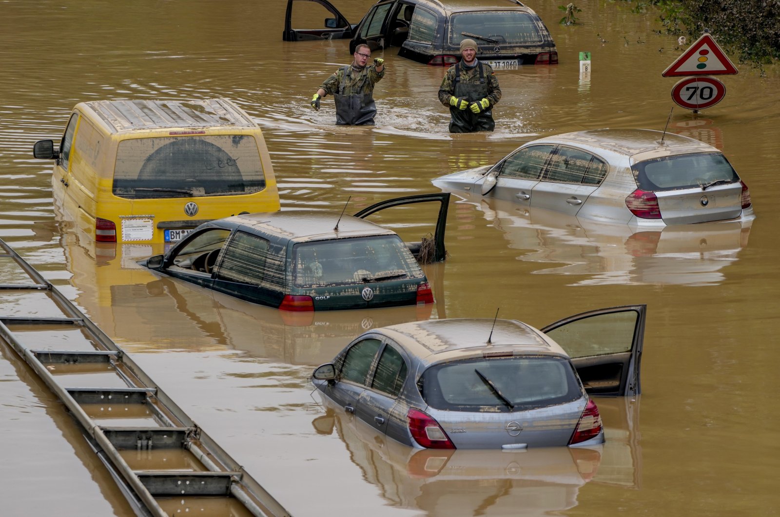 People check for victims in flooded cars on a road in Erftstadt, Germany, following heavy rainfall that broke the banks of the Erft river, causing extensive damage, July 17, 2021. (AP File Photo)