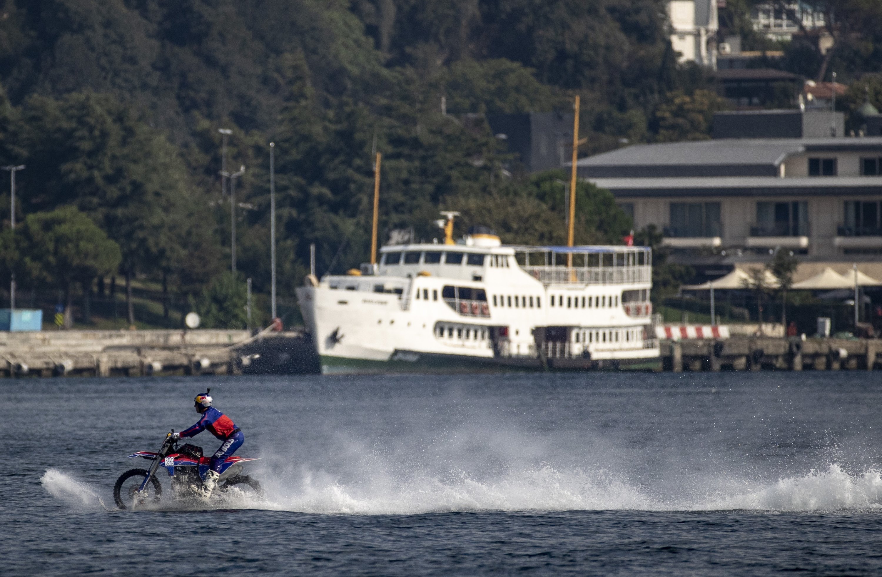 Motocross legend Robbie Maddison crosses the Bosporus on his motorbike. (AA Photo)