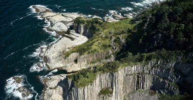 Russian-controlled Kunashir Island in Japan at low tide on a sunny day. (Shutterstock Photo)