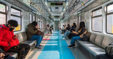 People check their smartphones in a subway, Seoul, South Korea, Jan. 28, 2018. (Shutterstock Photo)