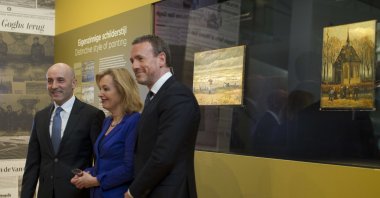 General Gianluigi D'Alfonso of the Italian Guardia Di Finanza (L) Jet Bussemaker, Minister for Education, Culture and Science (C) and Van Gogh Museum director Axel Rueger pose in front of two stolen and recovered van Gogh paintings, titled "Seascape at Scheveningen" (1882) and "Congregation leaving the Reformed Church in Nuenen," (1884-1885) during a press conference in Amsterdam, Netherlands, March 21, 2017. (AP Photo)