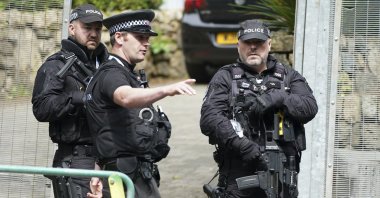 Police speak as they patrol a checkpoint in St. Ives, Cornwall, England, June 10, 2021. (AP Photo)