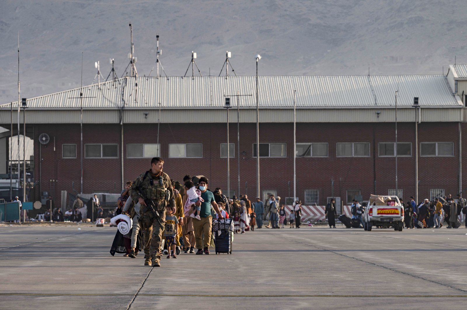 A U.S. Air Force officer guides evacuees to board a U.S. Air Force C-17 Globemaster III at Hamid Karzai International Airport in Kabul, Afghanistan, Aug. 24, 2021. (AP Photo)