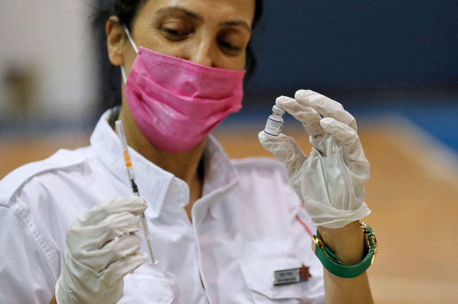 A paramedic with Israel's Magen David Adom medical service prepares to administer the third shot of the Pfizer-BioNTech COVID-19 vaccine, Holon, Israel, Aug. 24, 2021. (AFP Photo)