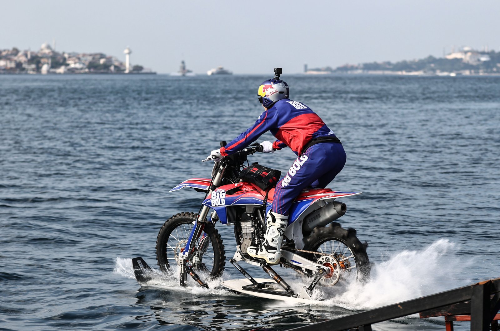 Motocross legend Robbie Maddison crosses the Bosporus on his motorbike. (AA Photo)