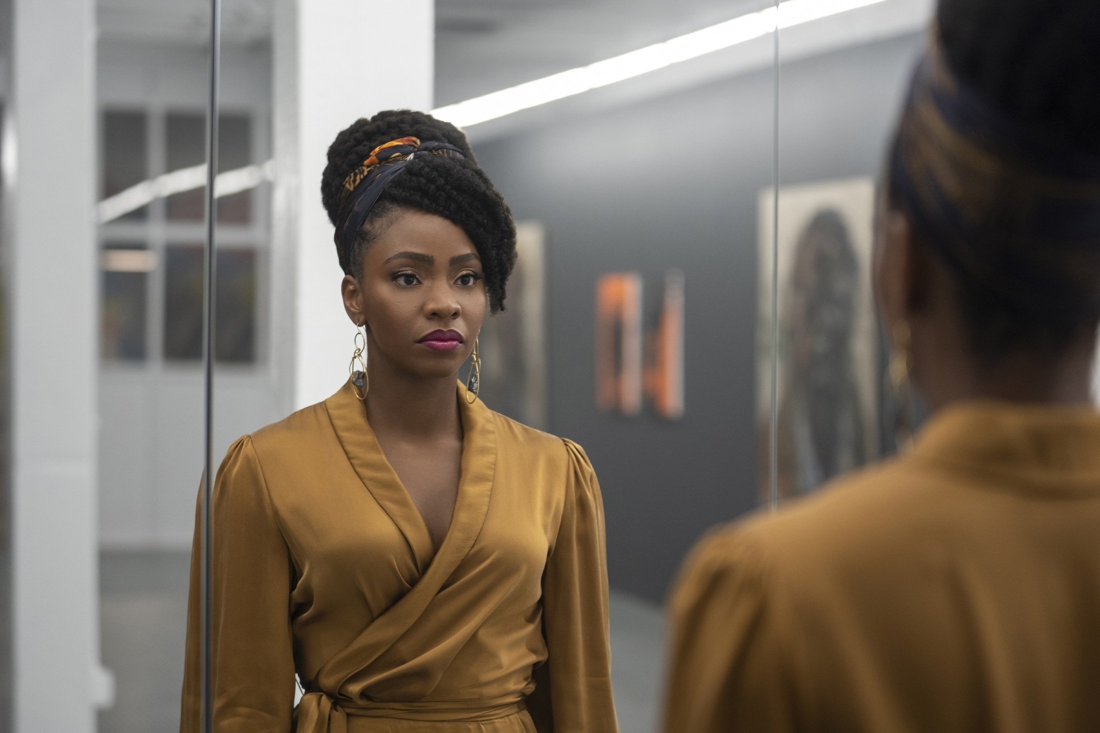 Teyonah Parris looks into a mirror, in a scene from the film “Candyman,” directed by Nia DaCosta. (AP Photo)