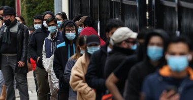 People wait in line outside a COVID-19 vaccination clinic in the Bankstown suburb during a lockdown to curb an outbreak of cases in Sydney, Australia, Aug. 25, 2021. (Reuters Photo)