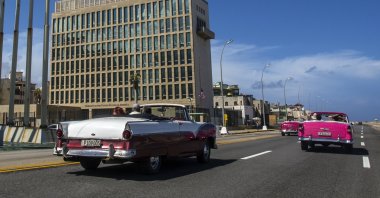 Tourists ride classic convertible cars on the Malecon beside the U.S. Embassy in Havana, Cuba, Oct. 3, 2017. (AP Photo)
