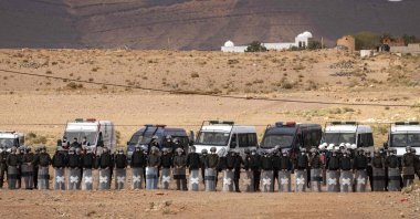 Moroccan security forces stand guard as Moroccan farmers protest in the city of Figuig after Algerian authorities expelled date growers from the Algerian territory, a border area they are traditionally authorized to farm, March 18, 2021. (AFP Photo)