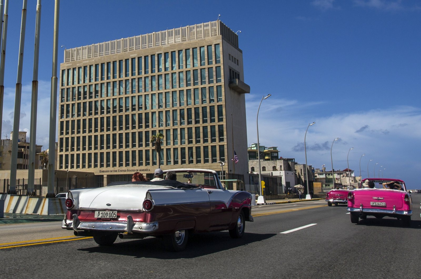 Tourists ride classic convertible cars on the Malecon beside the U.S. Embassy in Havana, Cuba, Oct. 3, 2017. (AP Photo)