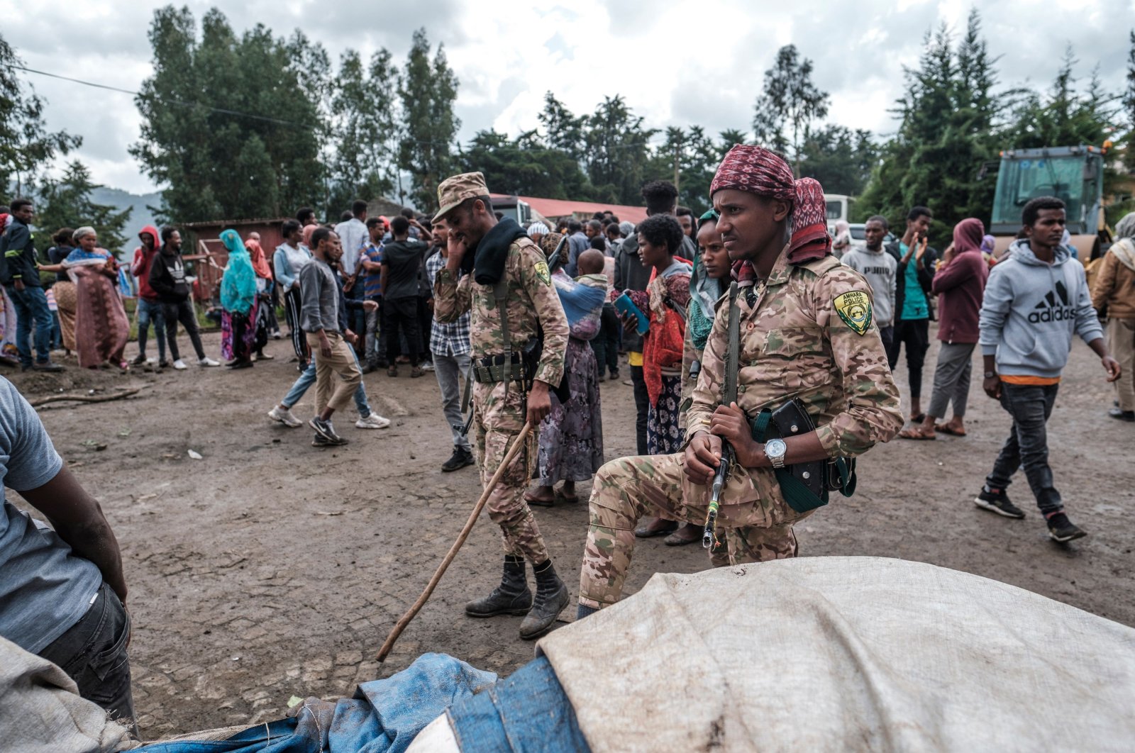 Members of the Special Force of the Amhara Police stand next to sacks of food during a food distribution for internally displaced people (IDP) from the Amhara region, in the city of Dessie, Ethiopia, Aug. 23, 2021. (Photo by Eduardo Soteras via AFP Photo)