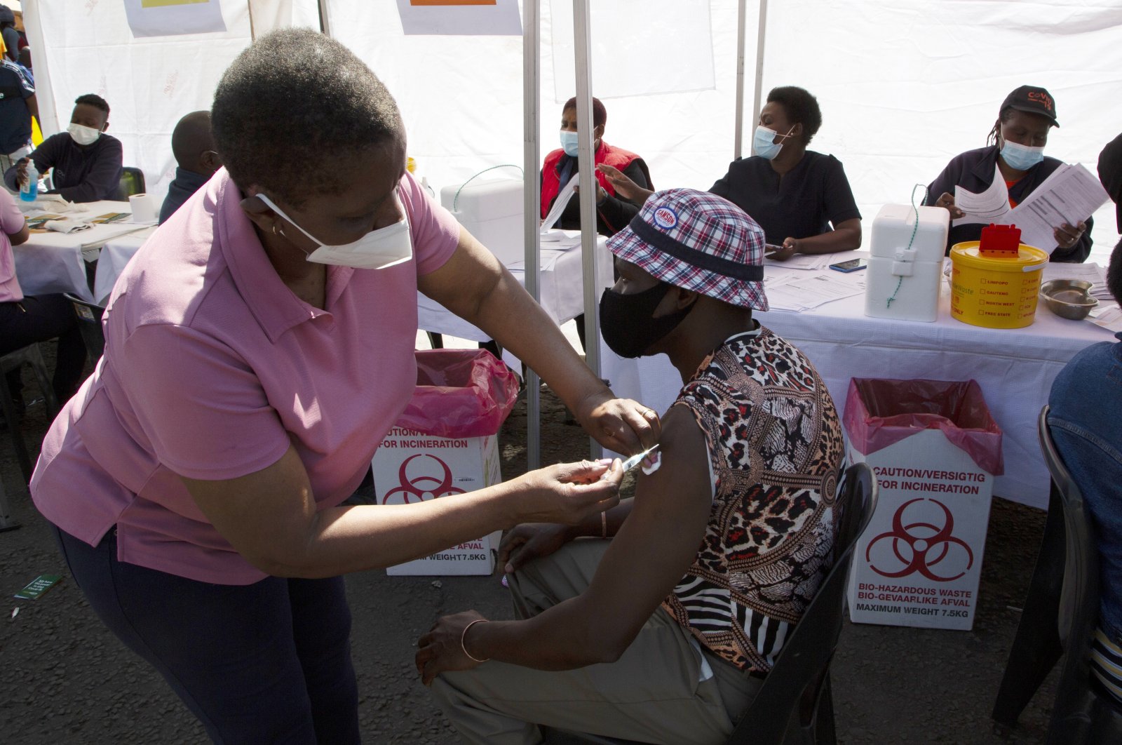 A patient receives Johnson & Johnson's Janssen COVID-19 vaccine at a pop-up vaccination center, at the Bare taxi rank in Soweto, South Africa, Aug. 20, 2021. (AP Photo)