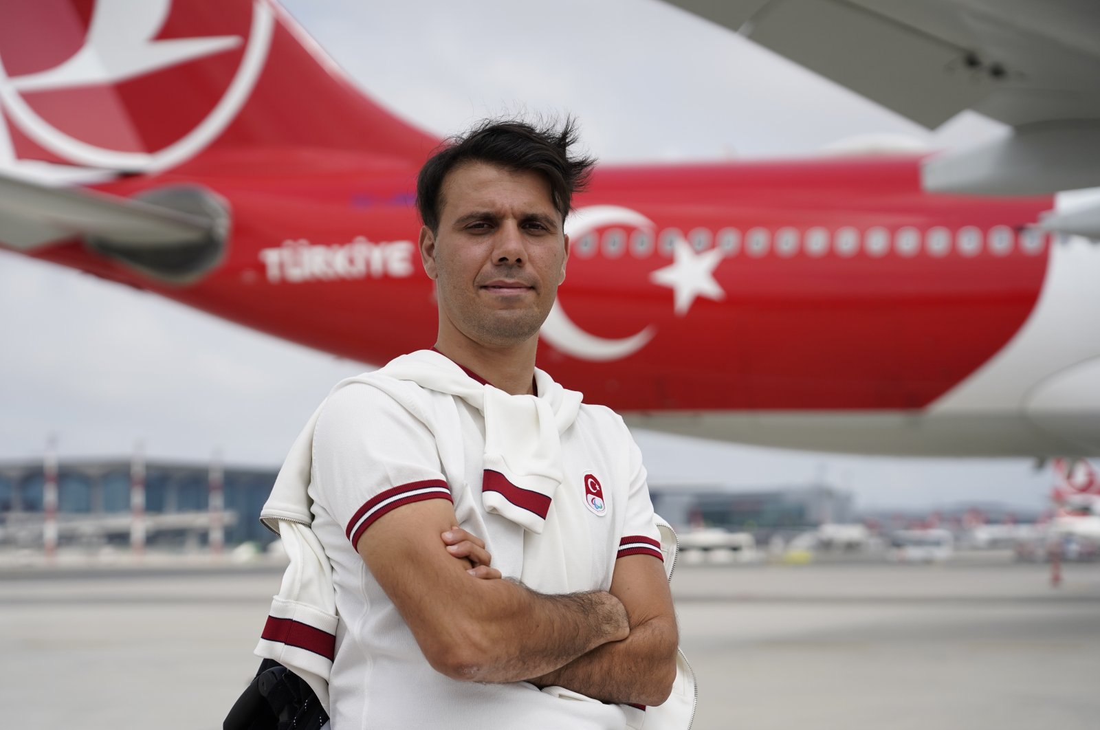 Turkish Paralympic archer Nihat Türkmenoğlu poses for a photo at the Istanbul Airport before departing for the Tokyo 2020 Paralympics, Istanbul, Turkey. (IHA Photo)