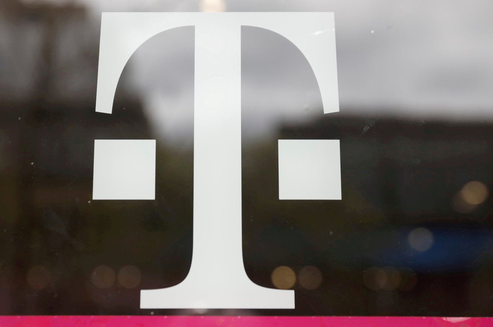 A T-Mobile logo is seen on the storefront door of a store in Manhattan, New York, U.S., April 30, 2018. (Reuters Photo)