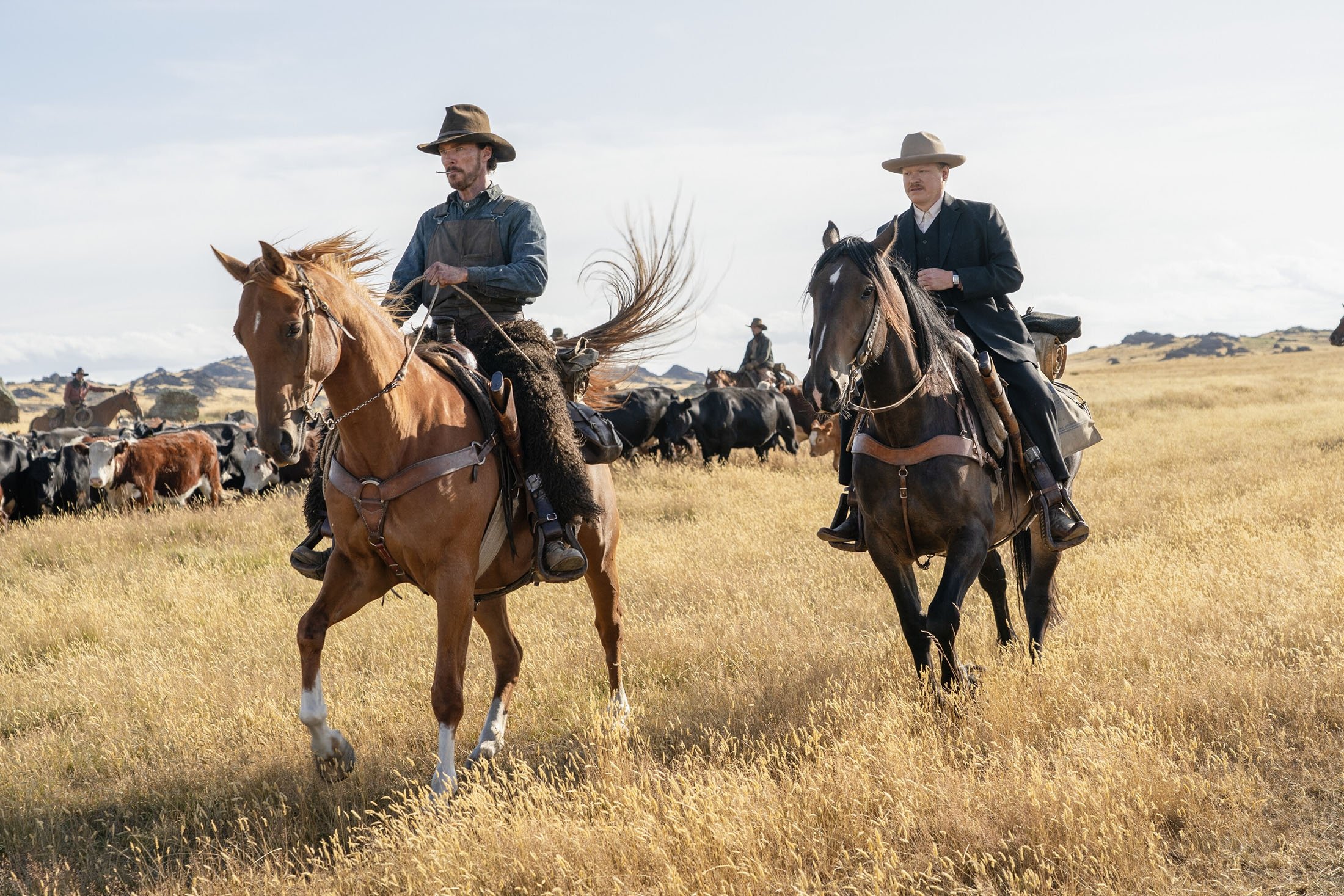Benedict Cumberbatch (L), and Jesse Plemons ride horses, in a scene from the film "The Power of the Dog." (Netflix via AP)